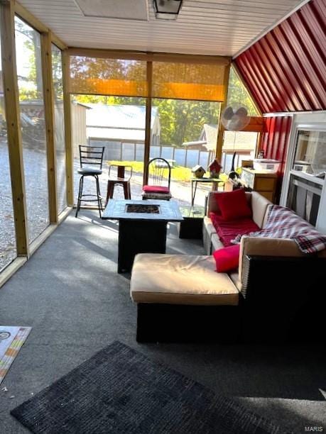 sunroom / solarium featuring vaulted ceiling