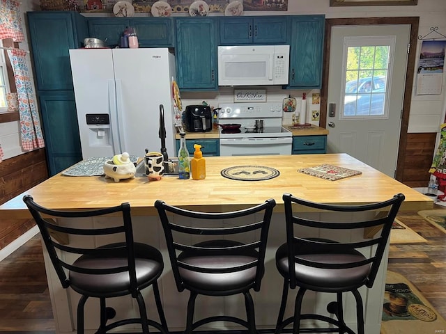 kitchen with a kitchen breakfast bar, white appliances, and blue cabinetry