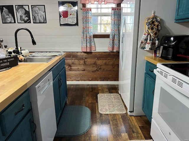 kitchen featuring wooden counters, white appliances, blue cabinets, sink, and dark hardwood / wood-style floors