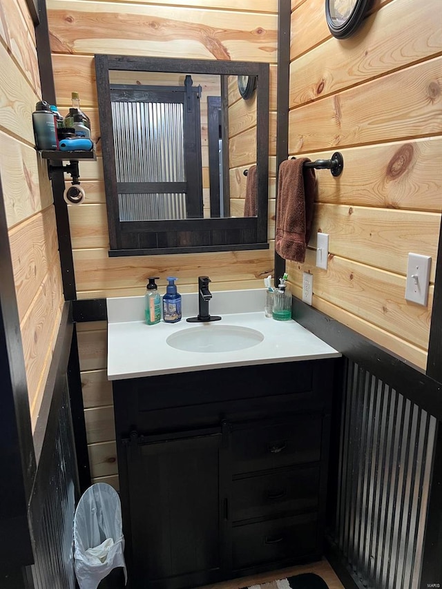 bathroom with wooden walls and vanity