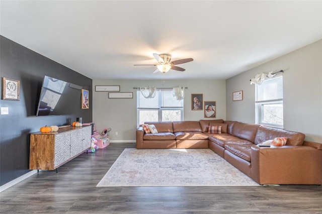 living room featuring dark hardwood / wood-style flooring, plenty of natural light, and ceiling fan