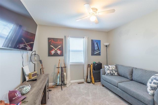 carpeted living room with ceiling fan