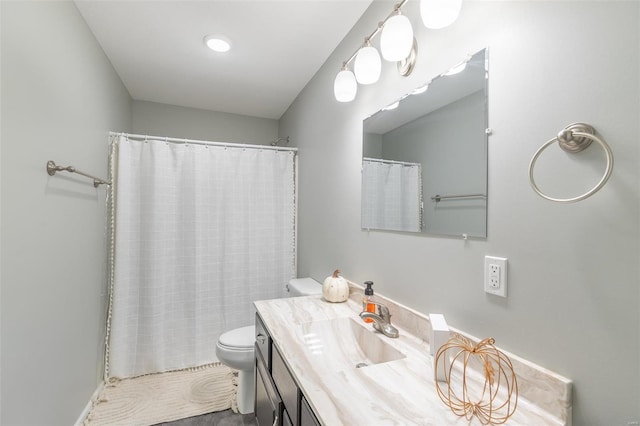 bathroom featuring vanity, toilet, and walk in shower