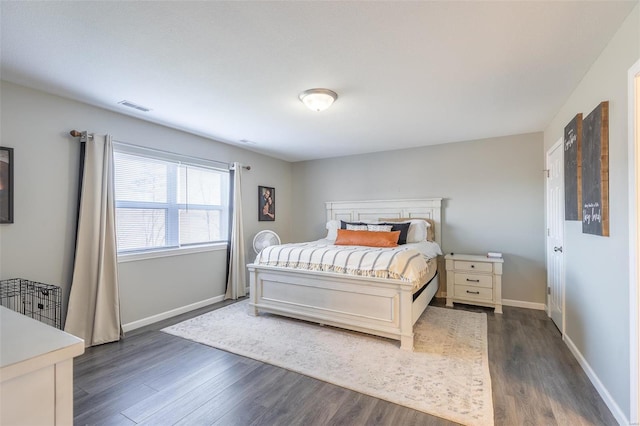 bedroom with dark wood-type flooring