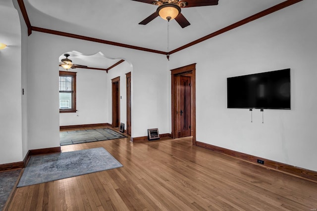 unfurnished living room with ceiling fan, wood-type flooring, and crown molding