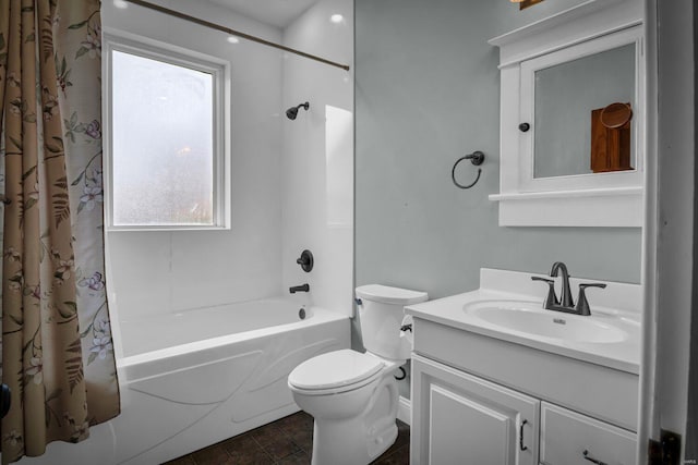 full bathroom featuring shower / bath combo, vanity, toilet, and a wealth of natural light