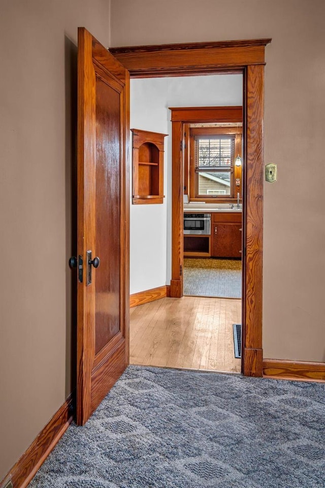 hallway featuring hardwood / wood-style flooring