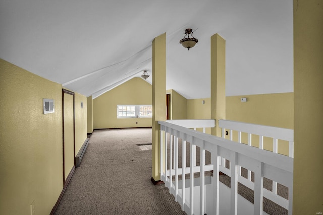 hallway with carpet, a baseboard radiator, and vaulted ceiling