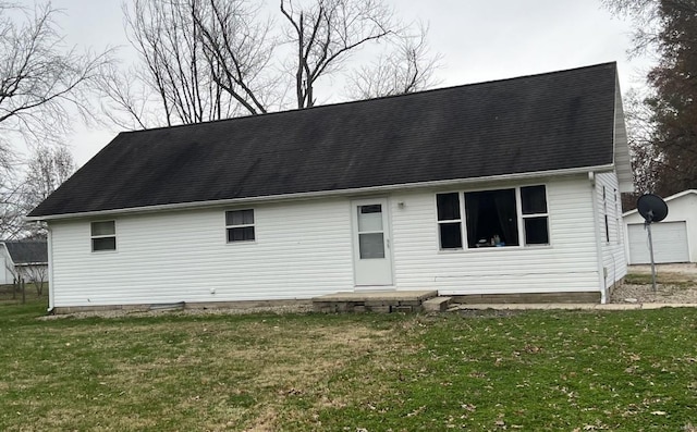 view of front facade featuring an outbuilding and a front lawn