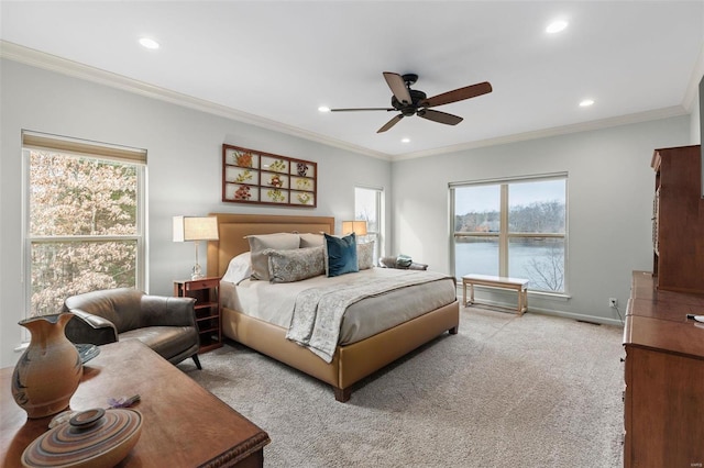 bedroom with recessed lighting, a water view, ornamental molding, carpet flooring, and baseboards