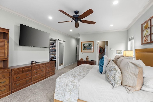 bedroom featuring a barn door, light colored carpet, a spacious closet, a closet, and recessed lighting