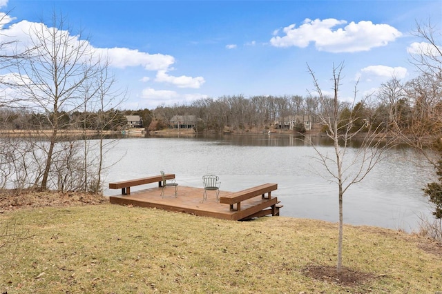 view of dock featuring a lawn and a water view