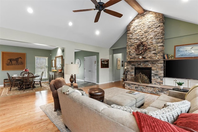 living room featuring a fireplace, wood finished floors, high vaulted ceiling, beamed ceiling, and baseboards