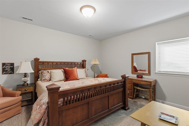 carpeted bedroom featuring visible vents