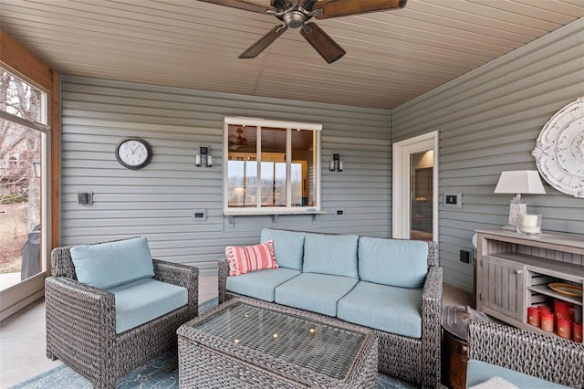 sunroom featuring ceiling fan