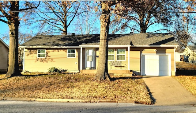 ranch-style home with driveway and an attached garage