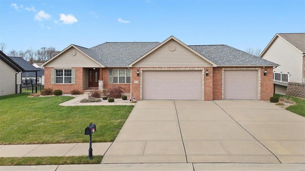 view of front facade with a front yard and a garage