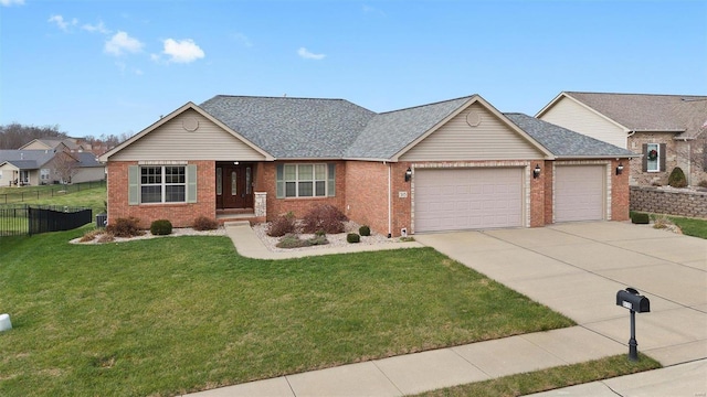 view of front of home with a front yard and a garage