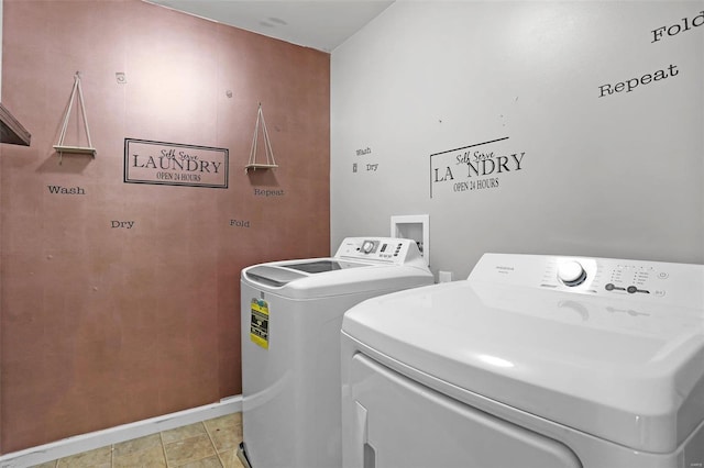 washroom featuring washer and dryer and light tile patterned floors