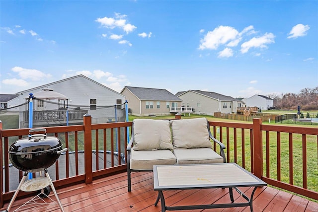 deck featuring outdoor lounge area, a yard, and grilling area