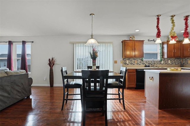 dining space with plenty of natural light, sink, and dark wood-type flooring