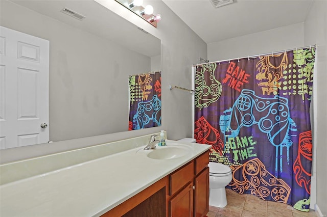 bathroom with tile patterned floors, vanity, and toilet