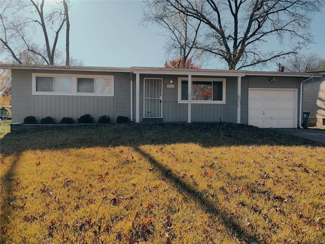 ranch-style home with a front yard and a garage