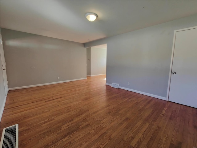 empty room with hardwood / wood-style flooring