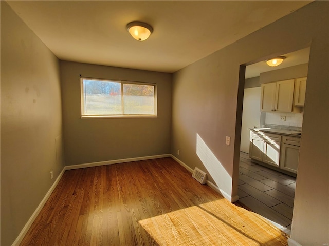 spare room with light hardwood / wood-style flooring