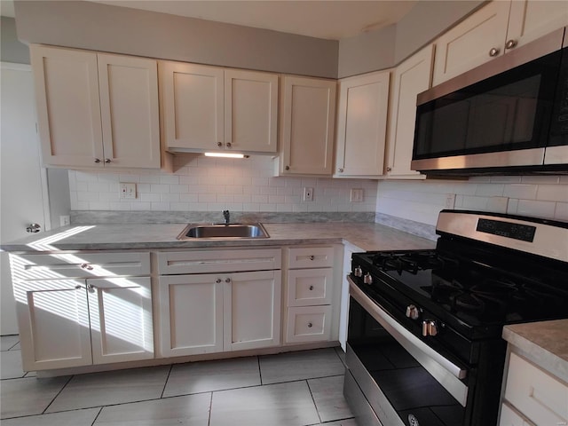 kitchen featuring white cabinets, backsplash, and stainless steel appliances