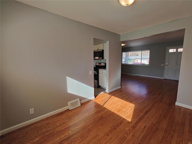 unfurnished room with hardwood / wood-style floors