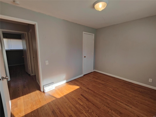 spare room with dark hardwood / wood-style flooring