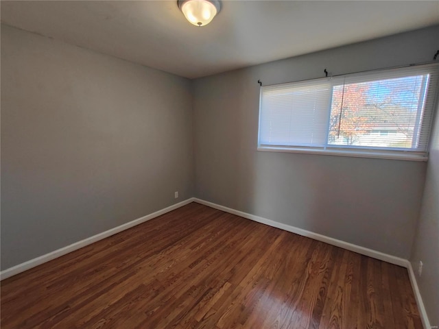 spare room with dark hardwood / wood-style floors