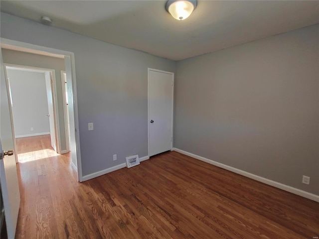 empty room featuring dark hardwood / wood-style flooring