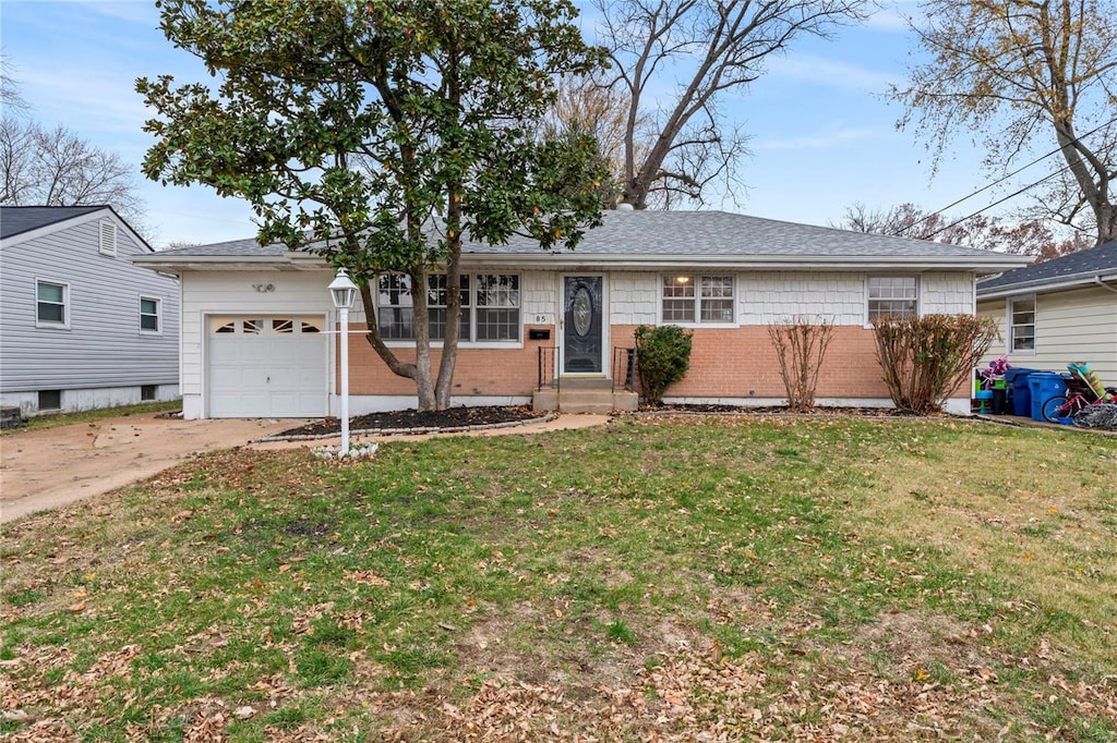 ranch-style house featuring a garage and a front yard