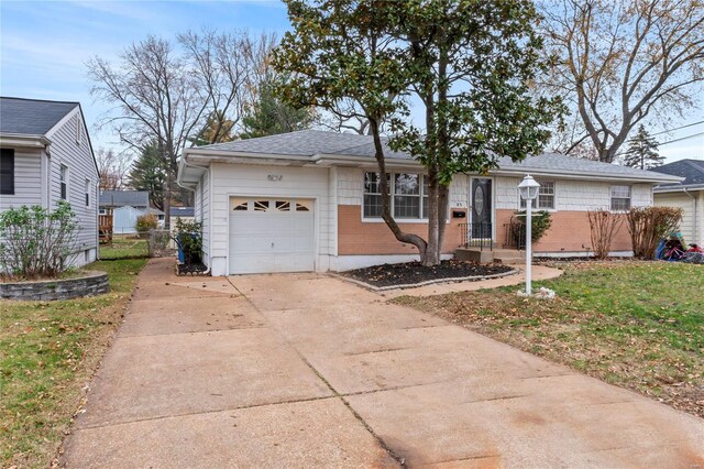 ranch-style house with a garage and a front yard