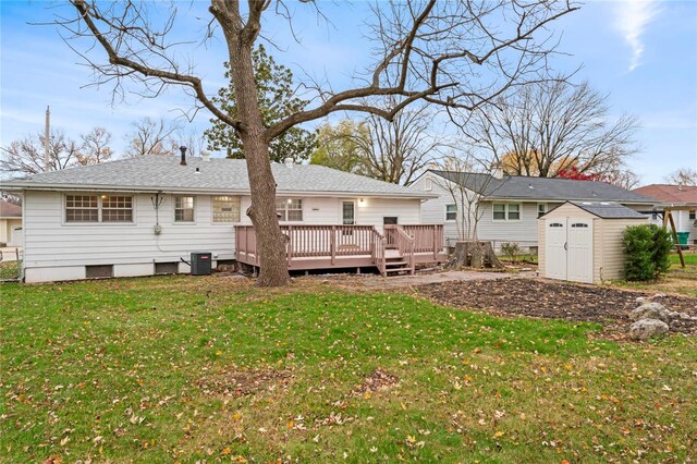 back of property featuring a yard, a deck, central AC unit, and a storage shed