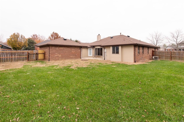 rear view of property featuring a lawn