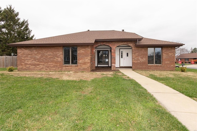 ranch-style home with a front lawn