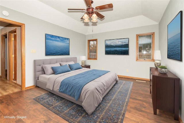 bedroom featuring ceiling fan, dark hardwood / wood-style flooring, and lofted ceiling