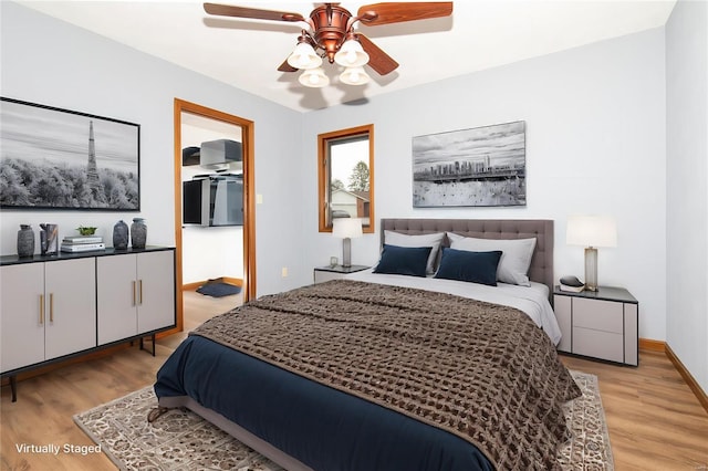 bedroom with ceiling fan and light hardwood / wood-style floors