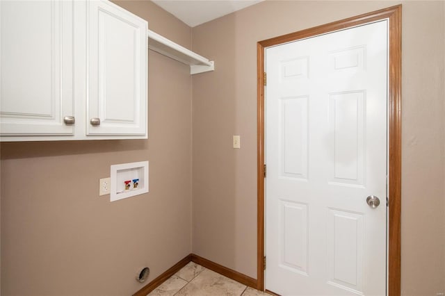 washroom featuring hookup for a washing machine, light tile patterned floors, and cabinets