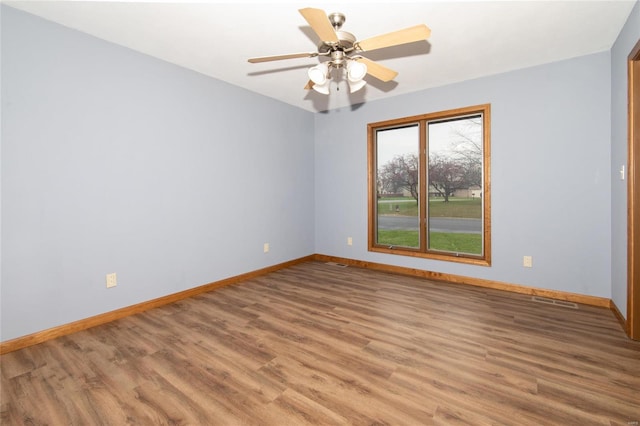 unfurnished room with hardwood / wood-style flooring and ceiling fan