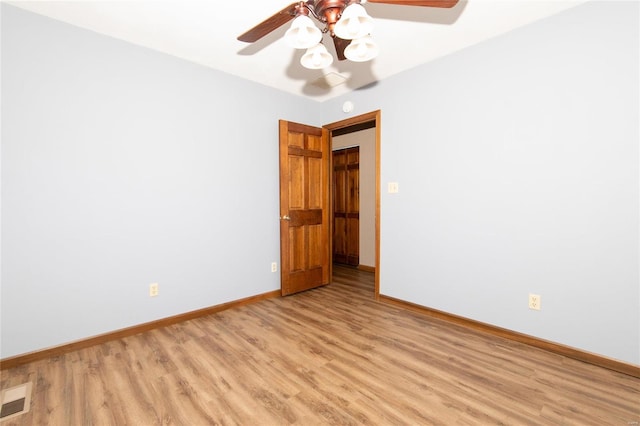 empty room with ceiling fan and light wood-type flooring