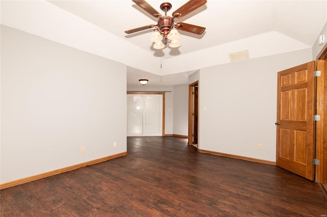 empty room with ceiling fan and dark wood-type flooring