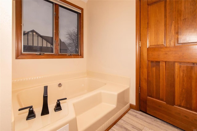 bathroom featuring hardwood / wood-style flooring and a tub