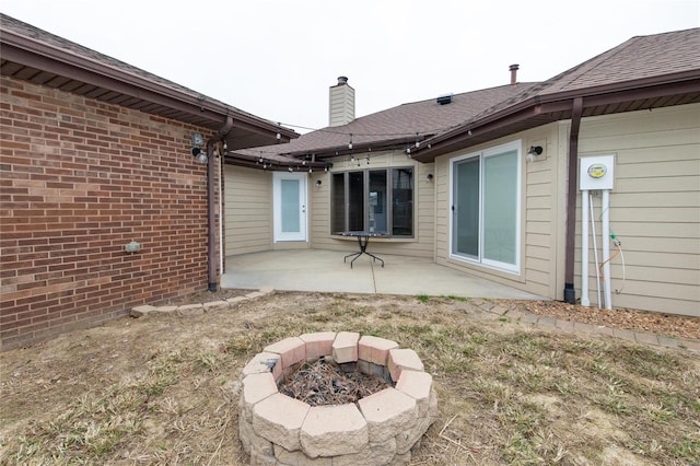 back of house with a patio area and an outdoor fire pit