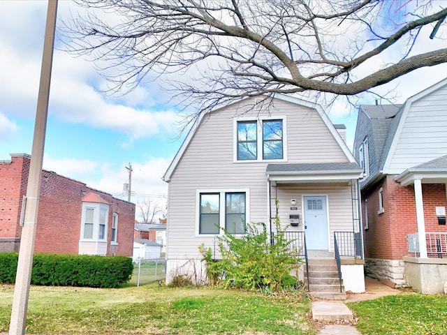 bungalow-style home with a front lawn