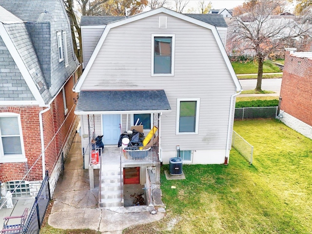 back of house featuring cooling unit and a yard