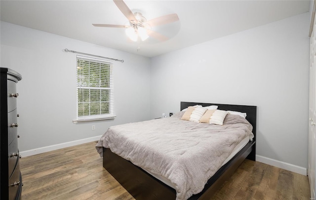 bedroom featuring hardwood / wood-style flooring and ceiling fan